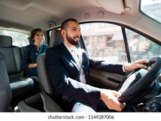 similing-taxi-driver-talking-female-260nw-1149287006