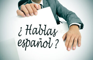 hablas-espanol-do-you-speak-spanish-written-spanish-man-wearing-suit-holding-signboard-sentence-35669276
