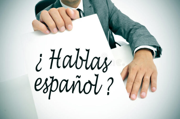 hablas-espanol-do-you-speak-spanish-written-spanish-man-wearing-suit-holding-signboard-sentence-35669276